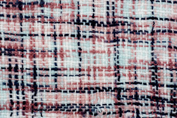 Checkered fabric for the background. Texture of a warm blanket close-up. Knitted fabric, cotton, wool background.
