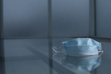 Medical protective mask on glass table
