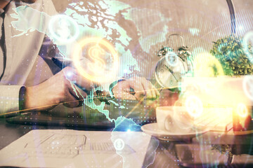 Double exposure of man's hands holding and using a phone and financial graph drawing. Analysis concept.