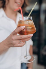 the girl holds a cocktail glass in her hand