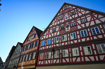 Colorful half-timbered houses under a clear blue sky in the city of Schwäbisch Hall, Germany under a clear blue sky.