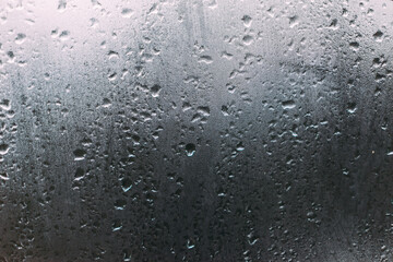 Foggy Moody rain and Mist on glass with grey skies 
