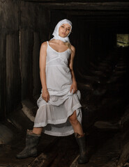 Stylish girl in a scarf and rubber boots in the tunnel