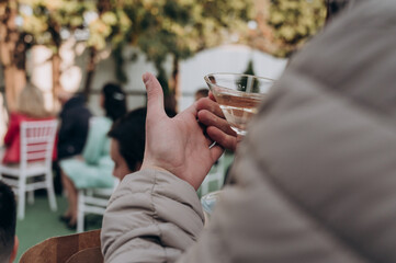 a man holds a glass of champagne in his hand