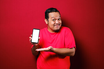 Portrait of Asian male looks happy and proud showing empty copy space smart phone