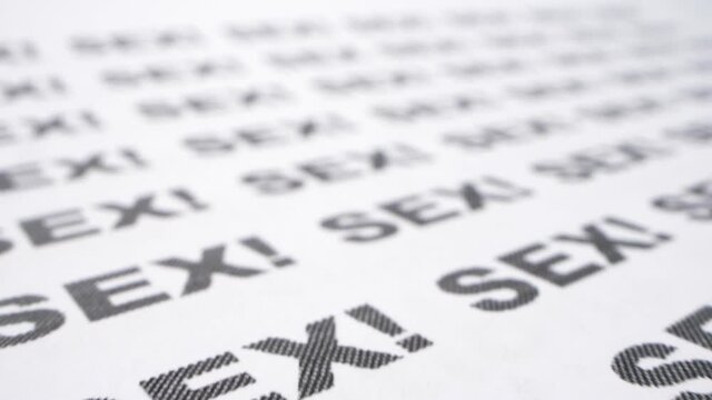 extremely close-up, detailed. the word sex written many times on a white piece of paper.