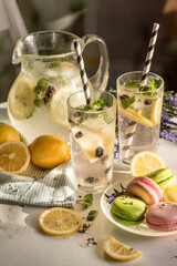 a romantic little table in a cafe in the sun, with lemonade and macaroon
