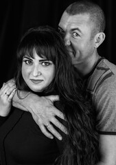 Black and white photoshoot of a couple in the studio