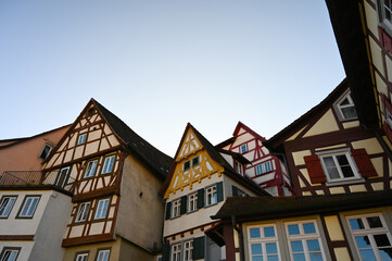 Colorful half-timbered houses under a clear blue sky in the city of Schwäbisch Hall, Germany. 