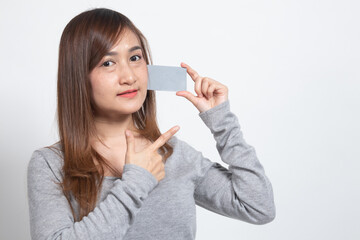 Young Asian woman point to a blank card.