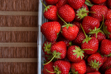 Strawberries in the glass bowl. Freshly picked strawberry. Organic sweet berries. Village garden harvest.