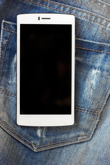 white smartphone on blue frayed jeans background hipster modern lifestyle mock up to insert text