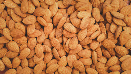 Background of big raw peeled almonds.Healthy food Concept.