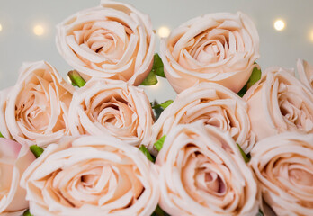 Beige roses bouquet with bokeh lights for romantic valentine concept.