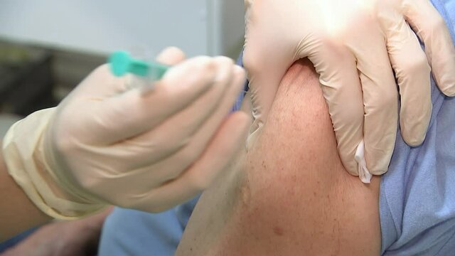 Doctor giving injection of coronavirus vaccine