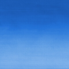 Blue ink and watercolor texture on white paper background. Gradient paint strokes and decalcomania effect. Hand-painted gouache abstract image. Mess on the canvas.