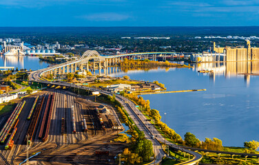 St Louis Bay in Duluth Minnesota shot from Skyline Drive. Railroad yards and Blatnik Bridge in Bay. Late Light - obrazy, fototapety, plakaty