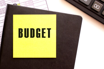 BUDGET text on a sticker on your desktop. Diary and calculator.