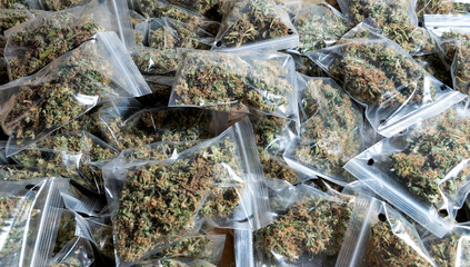 Horizontal photo of some bags of medical marihuana prepared for consumption.