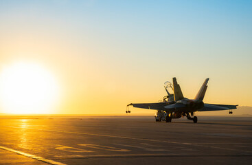 Jet fighter on an aircraft carrier deck against beautiful sunset sky . Elements of this image furnished by NASA - obrazy, fototapety, plakaty