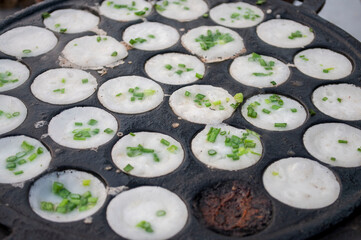 Kanom Krok, a traditional Thai dessert made from crushed coconut meat.