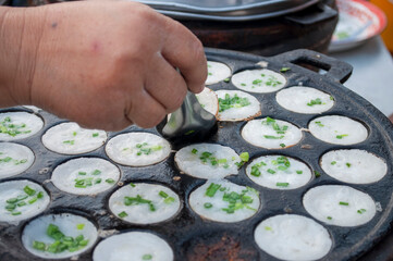 Kanom Krok Phueng, a traditional Thai dessert made from crushed coconut meat.