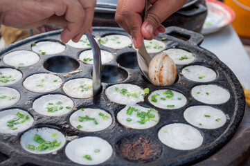 Kanom Krok Phueng, a traditional Thai dessert made from crushed coconut meat. - obrazy, fototapety, plakaty