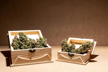 Ready-to-use medical marihuana buds inside two wooden boxes. Selective focus.