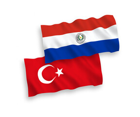 National vector fabric wave flags of Turkey and Paraguay isolated on white background. 1 to 2 proportion.