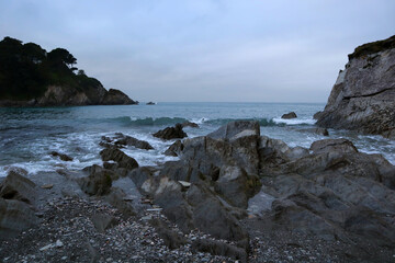 Fototapeta na wymiar sea waves breaking on the rock in the bay