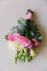 Pink, green and white wedding boutonniere for groom 