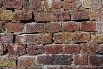 Brick texture.  Old red orange brown worn and weathered brick wall, clinker bricks.