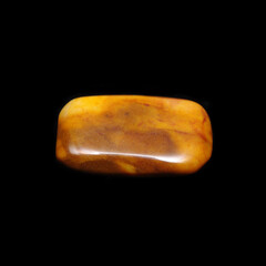 Tumbling jasper on black background 