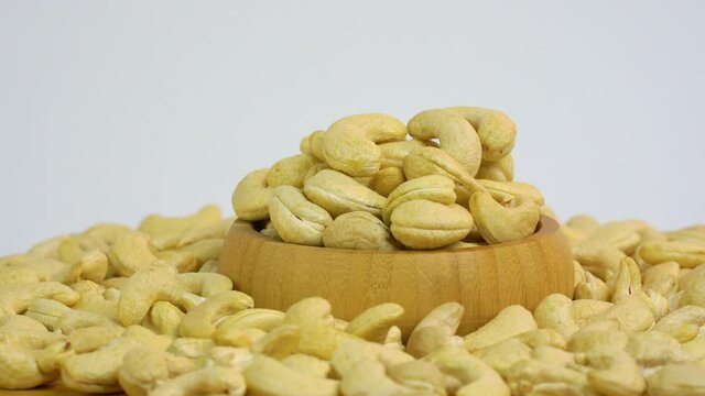 Cashews nuts on white background. Rotating footage nuts isolated on white background. Healthy food for dieting or snack. Copy space. Sale product.