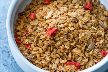 Oven Baked Artisan Granola with Dried Strawberries and Chia Seeds in Bowl.