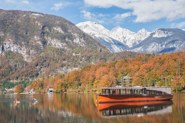 Pleasure boat and two rowers on the picturesque lake Bohinj. Triglav National Park in Slovenia in autumn © Виктор Осипенко