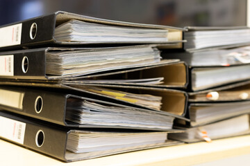 Close-up old files and papers of big folders in archives of business financial documents.