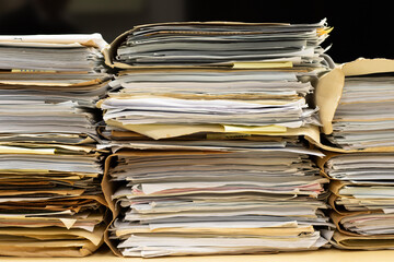 Close-up of files in folders stacking up in a messy order