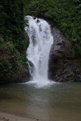 Beautiful view of rainforest waterfall in slow shutter mode.Soft focus due to slow shutter and high ISO shot.
