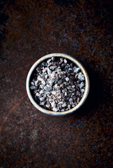 Black Himalayan Salt in a ceramic dish. Fro top