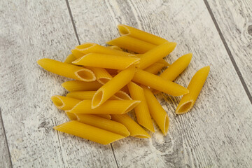 Raw penne pasta for bowl