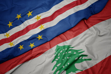 waving colorful flag of lebanon and national flag of cape verde.