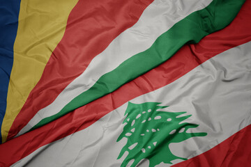 waving colorful flag of lebanon and national flag of seychelles.