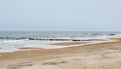 Horizontal shot of breakwaters in the Baltic sea, the seashore of Sarbinowo, Poland