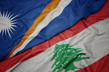 waving colorful flag of lebanon and national flag of Marshall Islands .