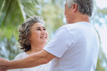 Obraz premium Happy asian senior retired couple, relax smiling elder man and woman enjoying with retired vacation at sea beach outdoor. Health care, Family outdoor lifestyle