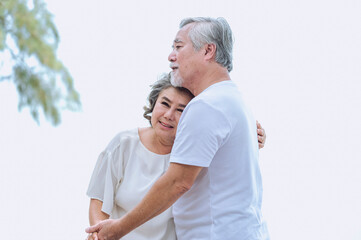 Happy asian senior retired couple, relax smiling elder man and woman enjoying with retired vacation at sea beach outdoor. Health care, Family outdoor lifestyle