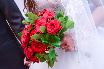 Wedding Day . The bride has handmade henna and towel. Red wedding bouquet. The bride was holding the bride in the car.