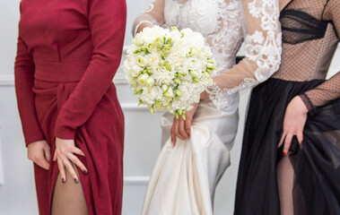 Obraz na płótnie Canvas Bride's bouquet in hands, white dress, wedding.