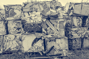Compressed aluminium scrap in large cubes forming landfill in piles.